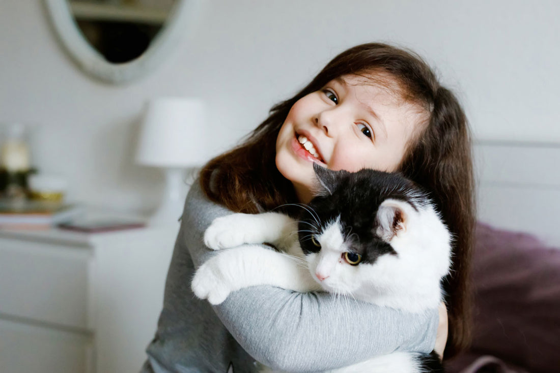 girl holding her pet cat